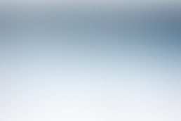 Soft gradient background shifting from blue to white.